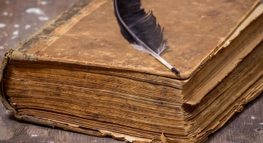 Old book with writing wedge